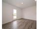 Bright living room features gray wood flooring, natural lighting, and neutral paint at 1265 Fleming Dr, Greenfield, IN 46140