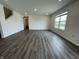 Spacious living room featuring wood-look floors and is illuminated by natural light from large windows at 1265 Fleming Dr, Greenfield, IN 46140