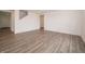 Bright living room featuring stylish gray wood flooring and neutral white walls at 1265 Fleming Dr, Greenfield, IN 46140