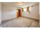 An empty bedroom featuring carpet flooring, closet and windows at 1303 S D St, Elwood, IN 46036