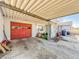 Spacious carport area with red garage door and plenty of storage space at 1303 S D St, Elwood, IN 46036