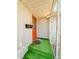Welcoming front porch with green turf and red door provides instant curb appeal at 1303 S D St, Elwood, IN 46036