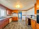 Bright kitchen with linoleum flooring and warm wood cabinets at 1303 S D St, Elwood, IN 46036