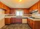 Traditional kitchen with wood cabinets, white countertops, and vintage appliances at 1303 S D St, Elwood, IN 46036