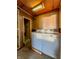 A laundry room featuring a washing machine and dryer with a doorway and additional storage at 1303 S D St, Elwood, IN 46036