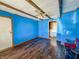 Cozy living room with bright blue walls and wood flooring at 1303 S D St, Elwood, IN 46036