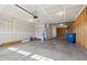 An unfinished two-car garage featuring concrete flooring, natural lighting, and the convenience of a water heater at 13204 Caterwood Cir, Fishers, IN 46037