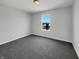 A cozy carpeted bedroom features a window with a view of the neighborhood at 15503 Sandlands Cir, Noblesville, IN 46060