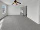 Neutral empty bedroom featuring gray carpet, white walls, a ceiling fan, and a single window at 15503 Sandlands Cir, Noblesville, IN 46060