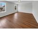 Neutral empty room featuring hardwood floors, white walls, a ceiling light and double windows at 15503 Sandlands Cir, Noblesville, IN 46060