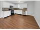 An open kitchen boasts white cabinets, stainless steel appliances, and sleek countertops at 15503 Sandlands Cir, Noblesville, IN 46060