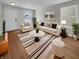 Bright living room featuring neutral walls, hardwood floors, a large sofa and lots of natural light at 15503 Sandlands Cir, Noblesville, IN 46060