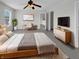 Stylized main bedroom with neutral carpet, walls and bedding, plus large windows and modern accents at 15503 Sandlands Cir, Noblesville, IN 46060