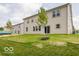 A lush green backyard with a newly planted tree and privacy fence at 1618 Trichel Dr, Greenwood, IN 46143
