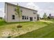 A spacious backyard featuring a lawn and a newly planted tree at 1618 Trichel Dr, Greenwood, IN 46143