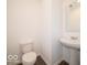 Half bathroom featuring a white sink, toilet, and a mirror at 1618 Trichel Dr, Greenwood, IN 46143