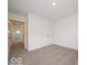 A carpeted bedroom featuring a closet and an open hallway at 1618 Trichel Dr, Greenwood, IN 46143