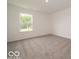 An airy carpeted bedroom with one window letting in natural light at 1618 Trichel Dr, Greenwood, IN 46143