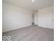 A large, light-filled bedroom with plush gray carpeting at 1618 Trichel Dr, Greenwood, IN 46143