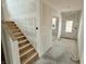 Spacious home entrance featuring staircase with unfinished walls and cement floors at 1618 Trichel Dr, Greenwood, IN 46143