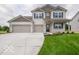 Charming two-story home featuring a spacious three-car garage and well-manicured front lawn at 1618 Trichel Dr, Greenwood, IN 46143