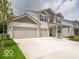 Charming two-story home featuring a spacious three-car garage and well-manicured front lawn at 1618 Trichel Dr, Greenwood, IN 46143