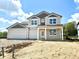 Charming two-story home featuring a three-car garage and covered porch, with gray and white trim at 1618 Trichel Dr, Greenwood, IN 46143