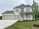 Charming two-story home featuring a three-car garage and a well-maintained front yard at 1618 Trichel Dr, Greenwood, IN 46143