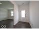 Bright foyer with dark hardwood floors and sidelight-adorned front door at 1618 Trichel Dr, Greenwood, IN 46143