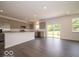 Modern kitchen with stainless steel appliances, gray cabinets, large island, and an adjacent eating area at 1618 Trichel Dr, Greenwood, IN 46143