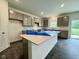 Spacious kitchen featuring gray cabinets, a large island with white countertop, and modern appliances at 1618 Trichel Dr, Greenwood, IN 46143