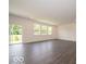 Bright living room with hardwood floors, recessed lighting, and sliding glass doors leading to the outdoors at 1618 Trichel Dr, Greenwood, IN 46143
