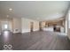 Spacious open-concept living area with kitchen featuring stainless appliances at 1618 Trichel Dr, Greenwood, IN 46143