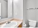 Cozy bathroom featuring a sink, mirror, and toilet at 2011 Blue Pine Ln, Indianapolis, IN 46231