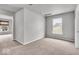Well-lit bedroom boasts neutral carpet, light gray walls and a window bringing in natural light at 2011 Blue Pine Ln, Indianapolis, IN 46231