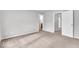 Light gray bedroom with neutral carpet leading to a bathroom and closet at 2011 Blue Pine Ln, Indianapolis, IN 46231