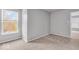 Bright bedroom with carpet, two windows and a view to the outdoors at 2011 Blue Pine Ln, Indianapolis, IN 46231
