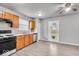 Well-equipped kitchen with wood cabinets, stainless steel appliances, and an adjacent dining area at 2011 Blue Pine Ln, Indianapolis, IN 46231