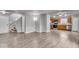 Open-concept living room featuring hardwood floors and direct access to the kitchen at 2011 Blue Pine Ln, Indianapolis, IN 46231