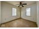 Bright bedroom featuring two windows, ceiling fan and classic flooring at 2207 E Dudley Ave, Indianapolis, IN 46227