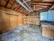 Inside of the garage showcasing storage shelves and exposed rafters at 2207 E Dudley Ave, Indianapolis, IN 46227
