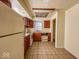 A kitchen has wood cabinets, a white refrigerator and stove, and vinyl tile flooring at 2207 E Dudley Ave, Indianapolis, IN 46227