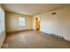 An empty living room has natural light from the window and access to the kitchen at 2207 E Dudley Ave, Indianapolis, IN 46227
