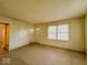 The empty living room has natural light coming through the window and a doorway to another room at 2207 E Dudley Ave, Indianapolis, IN 46227