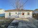 View of rear of home with door and patio against bare lawn at 2207 E Dudley Ave, Indianapolis, IN 46227
