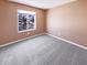 Comfortable bedroom features a large window and plush carpeting, ready for your personal touch at 2257 Grand Fir Dr, Greenwood, IN 46143