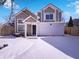 Two-story home features a covered entry, two-car garage, and snow-covered front yard on a sunny winter day at 2257 Grand Fir Dr, Greenwood, IN 46143