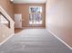 Bright living room features soft carpet, neutral walls, large window, and plenty of natural light at 2257 Grand Fir Dr, Greenwood, IN 46143