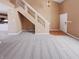 Spacious living room featuring staircase, neutral paint, and access to the kitchen at 2257 Grand Fir Dr, Greenwood, IN 46143
