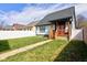 Well-maintained backyard with a wooden porch and lush green grass, great for relaxation at 2432 N Talbott St, Indianapolis, IN 46205